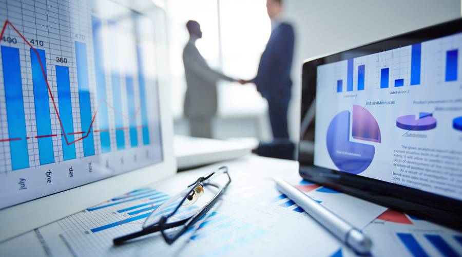Business charts and handshake collaboration meeting.
