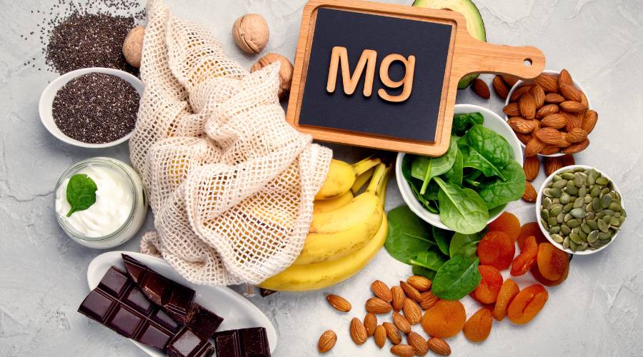 Magnesium-rich foods including bananas, nuts, and spinach.
